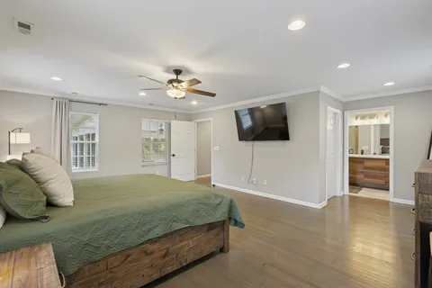 a bedroom with a bed and a flat screen tv