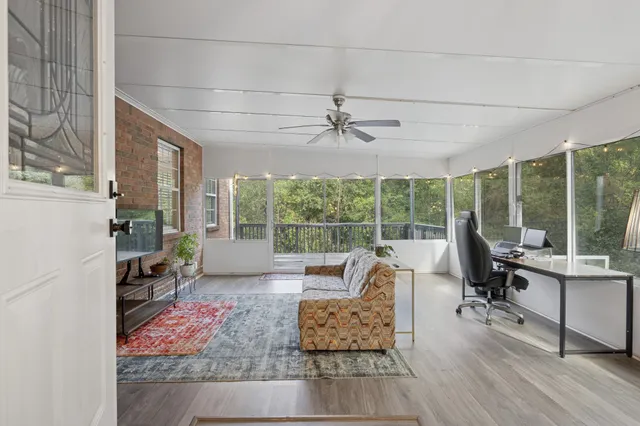 a living room with furniture and large windows
