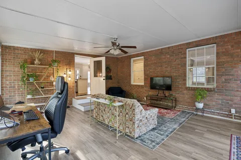 a bedroom with furniture and a flat screen tv