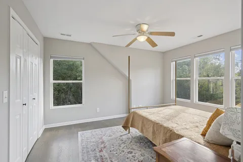 a bedroom with a large bed and a window