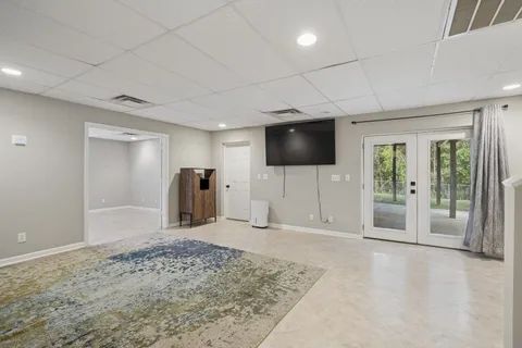 a view of a livingroom with wooden floor and a flat screen tv