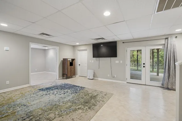 a view of a livingroom with wooden floor and a flat screen tv
