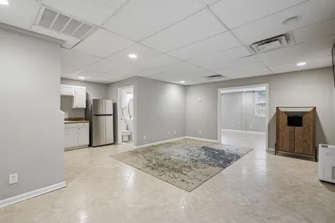 a view of a kitchen with a sink and a refrigerator