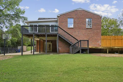 a view of a house with a yard and sitting area