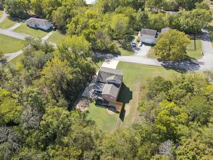 an aerial view of a house with a yard swimming pool and outdoor seating
