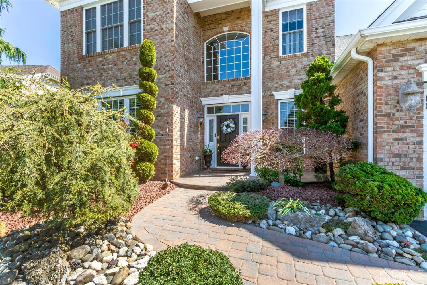 28 Kings Mill Road Monroe Township, NJ 08831 - Photo 2 of 42 a front view of a multi story residential apartment building with a yard and potted plants