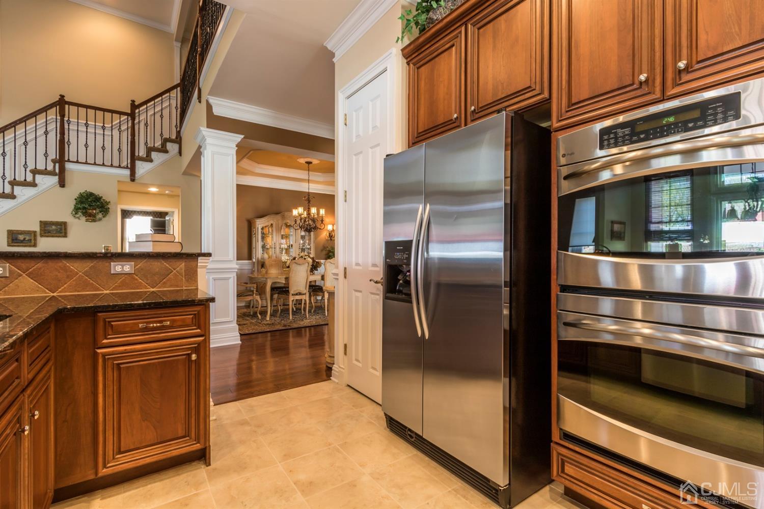 28 Kings Mill Road Monroe Township, NJ 08831 - Photo 15 of 42 a kitchen with granite countertop a refrigerator and cabinets