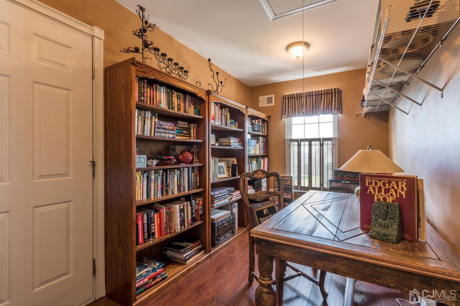 28 Kings Mill Road Monroe Township, NJ 08831 - Photo 36 of 42 a living room with furniture and a book shelf