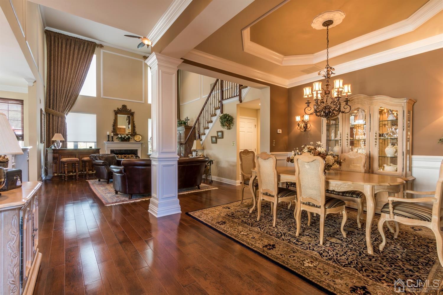 28 Kings Mill Road Monroe Township, NJ 08831 - Photo 6 of 42 a dining room with wooden floor a chandelier a wooden table and chairs