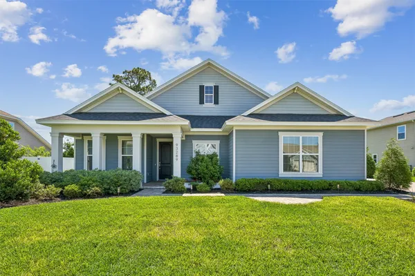 a front view of a house with a yard and porch