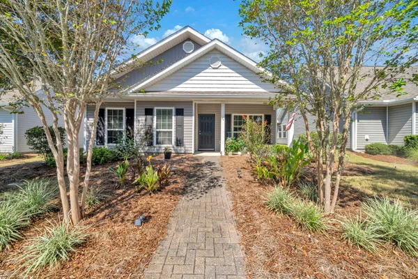 a front view of a house with garden