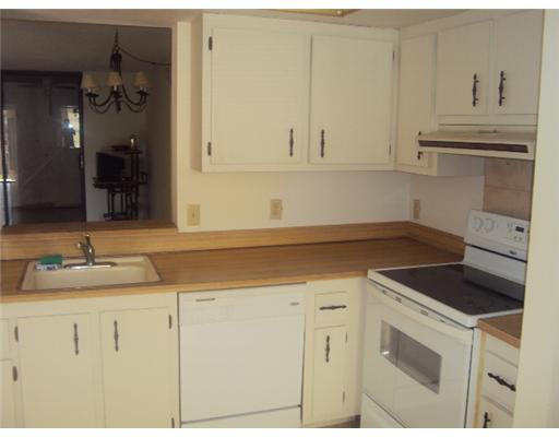 7331 Northwest 18th Street, Unit 204 Margate, FL 33063 - Photo 2 of 15 a kitchen with granite countertop white cabinets and white appliances