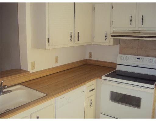 7331 Northwest 18th Street, Unit 204 Margate, FL 33063 - Photo 3 of 15 a kitchen with granite countertop white cabinets and white appliances