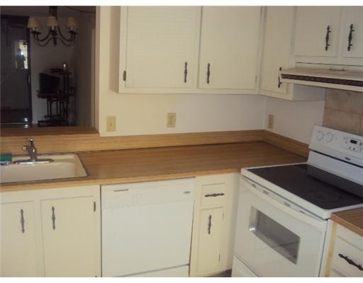 7331 Northwest 18th Street, Unit 204 Margate, FL 33063 - Photo 5 of 15 a kitchen with granite countertop white cabinets and white appliances