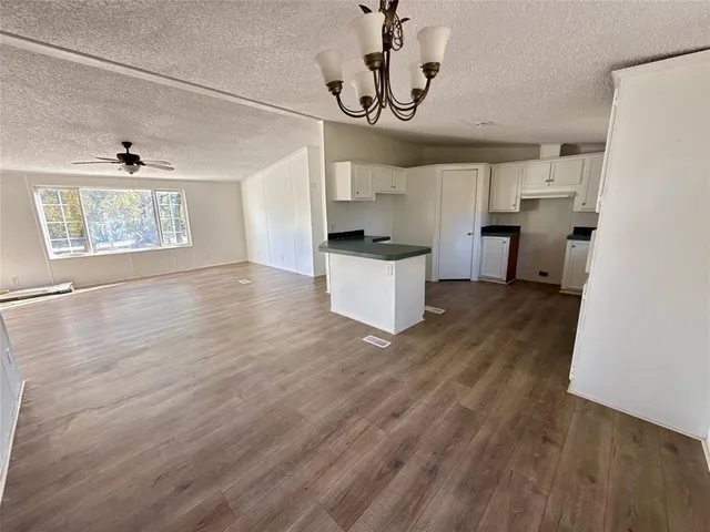 a view of a kitchen with a sink and wooden floor