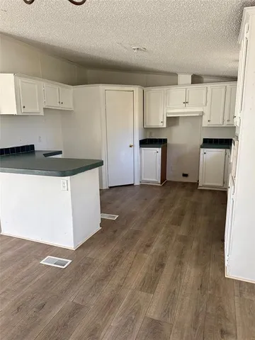 a kitchen with granite countertop a stove and a refrigerator