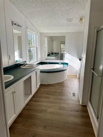 a large white kitchen with sink and refrigerator
