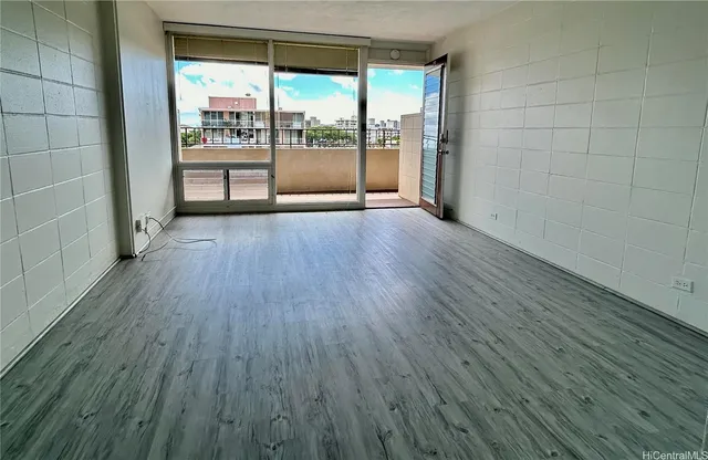 a room with wooden floor and a window
