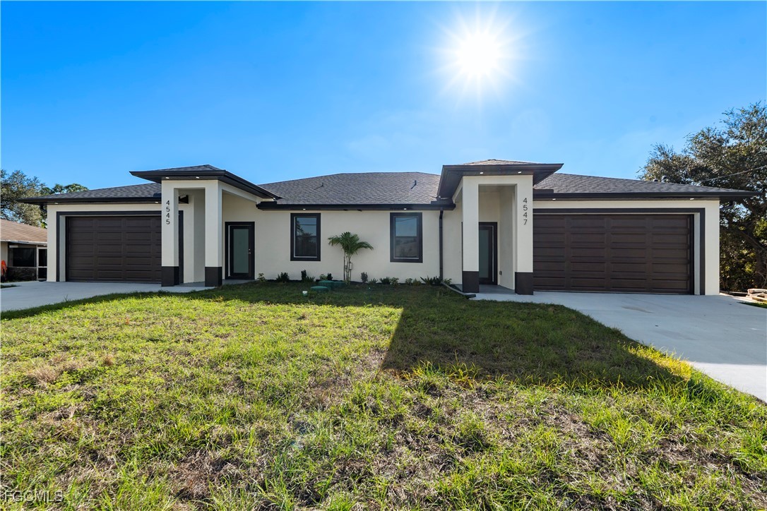 4545-4547 28th Street Southwest Lehigh Acres, FL 33973 - Photo 1 of 38 front view of a house with a yard