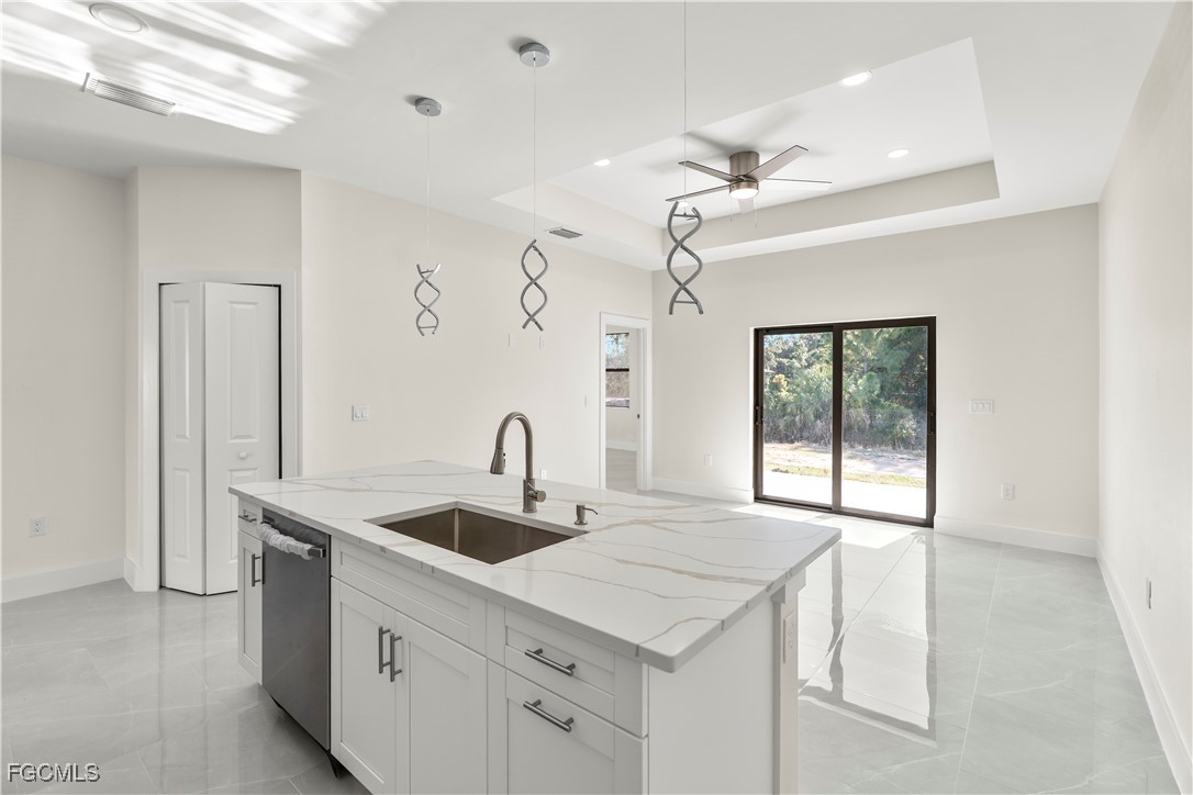 4545-4547 28th Street Southwest Lehigh Acres, FL 33973 - Photo 13 of 38 a kitchen with a sink a counter space and a refrigerator