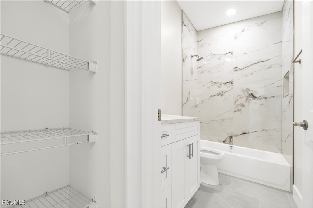 4545-4547 28th Street Southwest Lehigh Acres, FL 33973 - Photo 15 of 38 a bathroom with a toilet and a bathtub