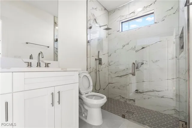 an empty room with a window and a ceiling fan