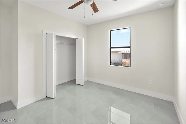 a view of a hallway with a ceiling fan