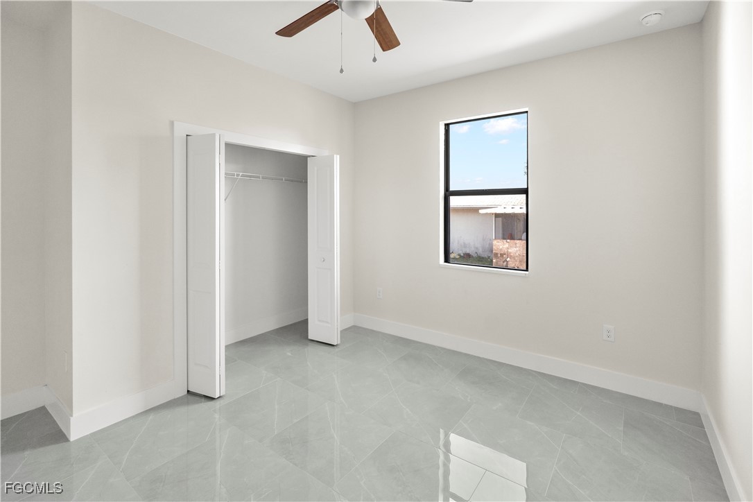 4545-4547 28th Street Southwest Lehigh Acres, FL 33973 - Photo 28 of 38 an empty room with a window and ceiling fan