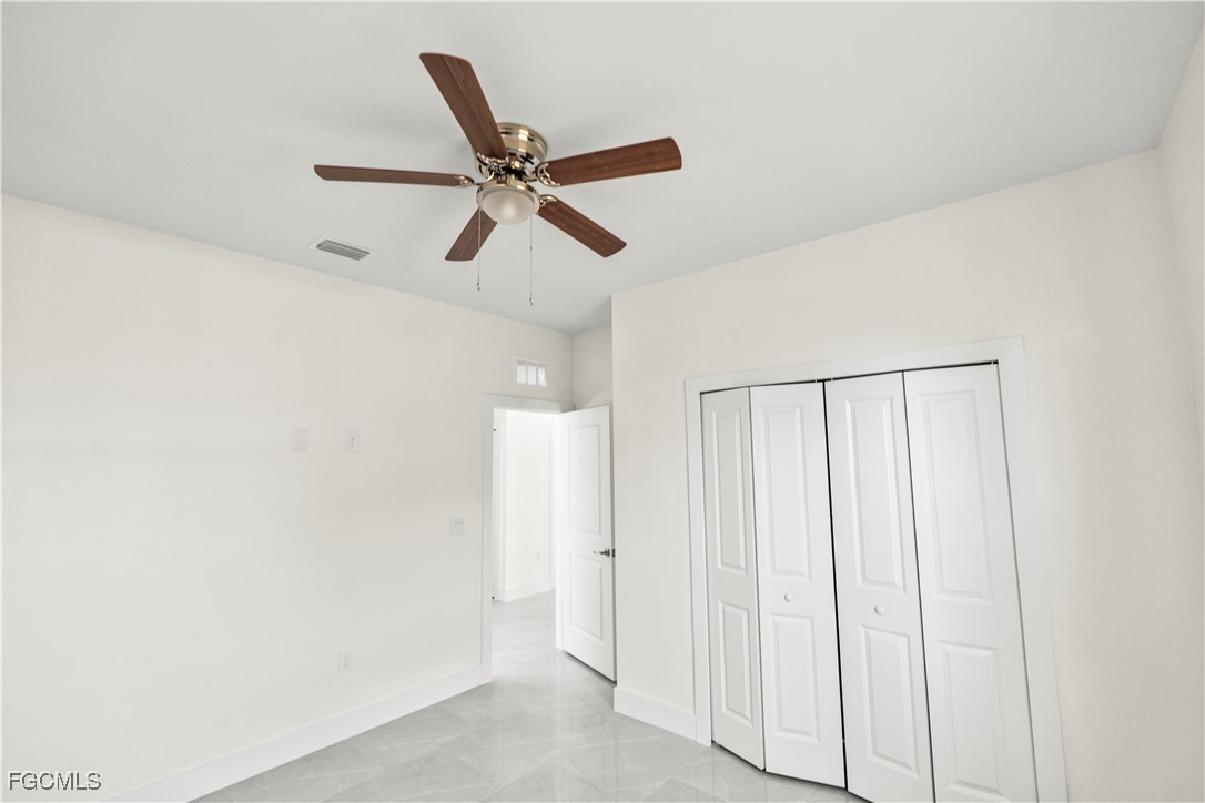 4545-4547 28th Street Southwest Lehigh Acres, FL 33973 - Photo 29 of 38 a view of a hallway with a ceiling fan