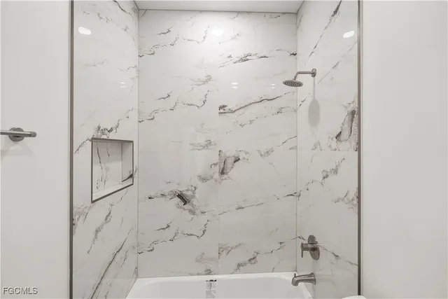 a bathroom with a granite countertop sink a toilet and shower