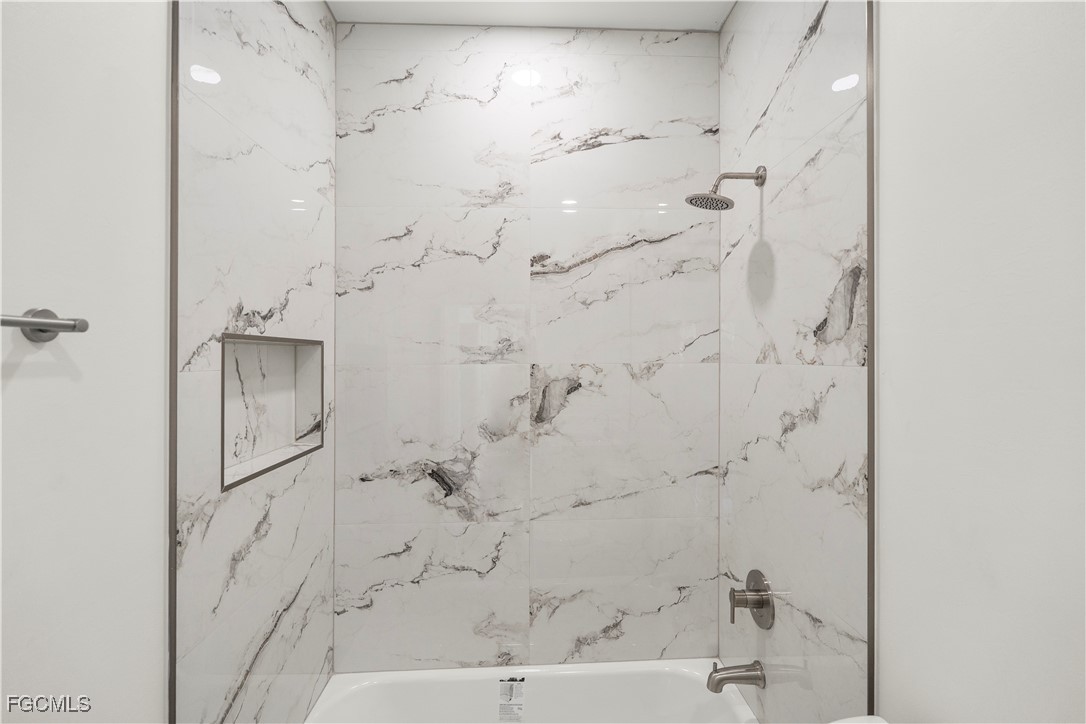 4545-4547 28th Street Southwest Lehigh Acres, FL 33973 - Photo 31 of 38 a bathroom with a bathtub and shower