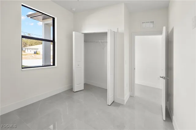 a view of a glass door with a yard from a room