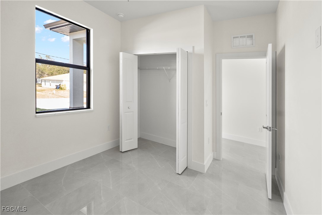 4545-4547 28th Street Southwest Lehigh Acres, FL 33973 - Photo 34 of 38 a view of an empty room with window and bathroom