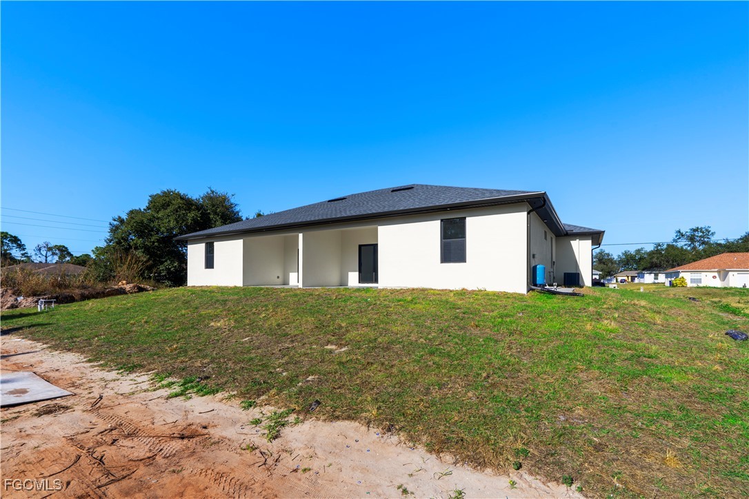 4545-4547 28th Street Southwest Lehigh Acres, FL 33973 - Photo 6 of 38 a view of a house with a yard