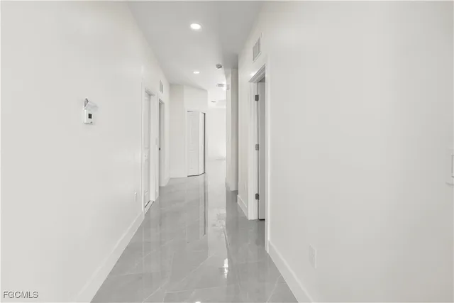 a kitchen with granite countertop a refrigerator and a stove top oven