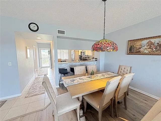 a view of a house with swimming pool and sitting area