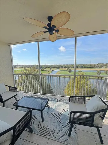a living room with furniture a rug and a chandelier
