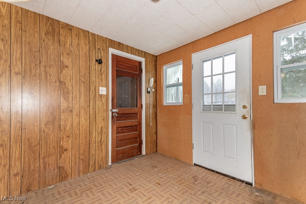 3303 River Road Perry, OH 44081 - Photo 11 of 34 Doorway with wooden walls and light parquet flooring
