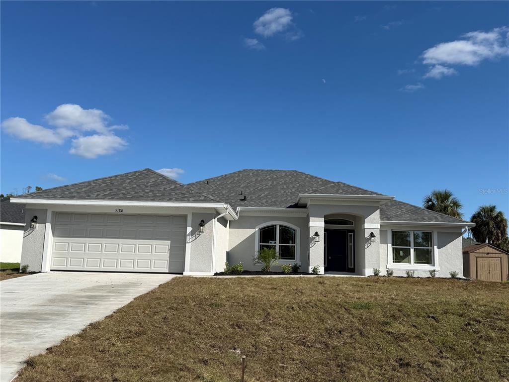 5180 Duma Way North Port, FL 34286 - Photo 1 of 1 a front view of a house with a yard and garage