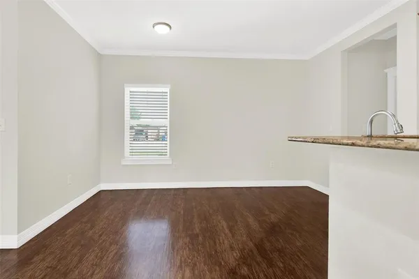 a view of a small space with wooden floor and a window