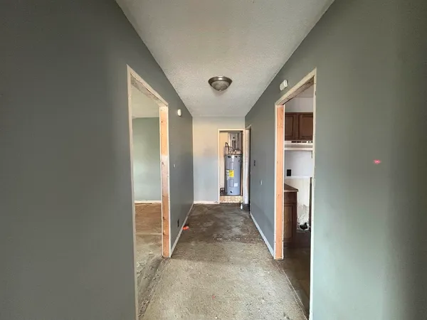 a view of a hallway with wooden shelves