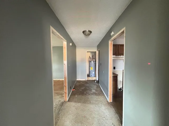 a view of a hallway with wooden shelves