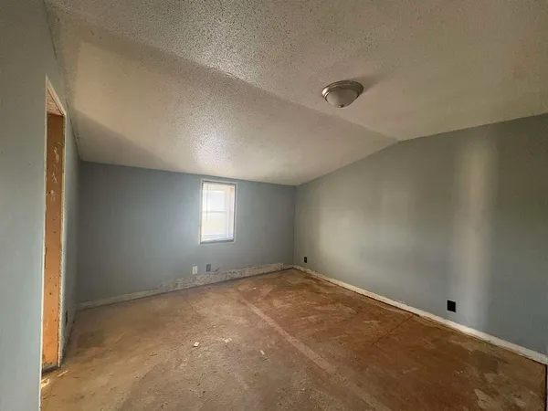 an empty room with a empty space and windows