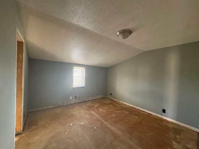 an empty room with a empty space and windows