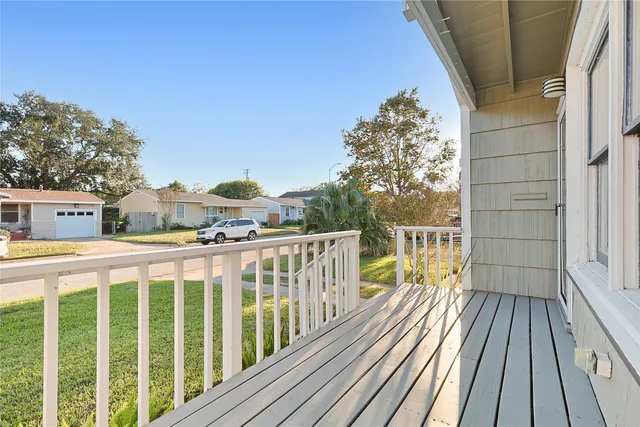 a view of a balcony with wooden floor
