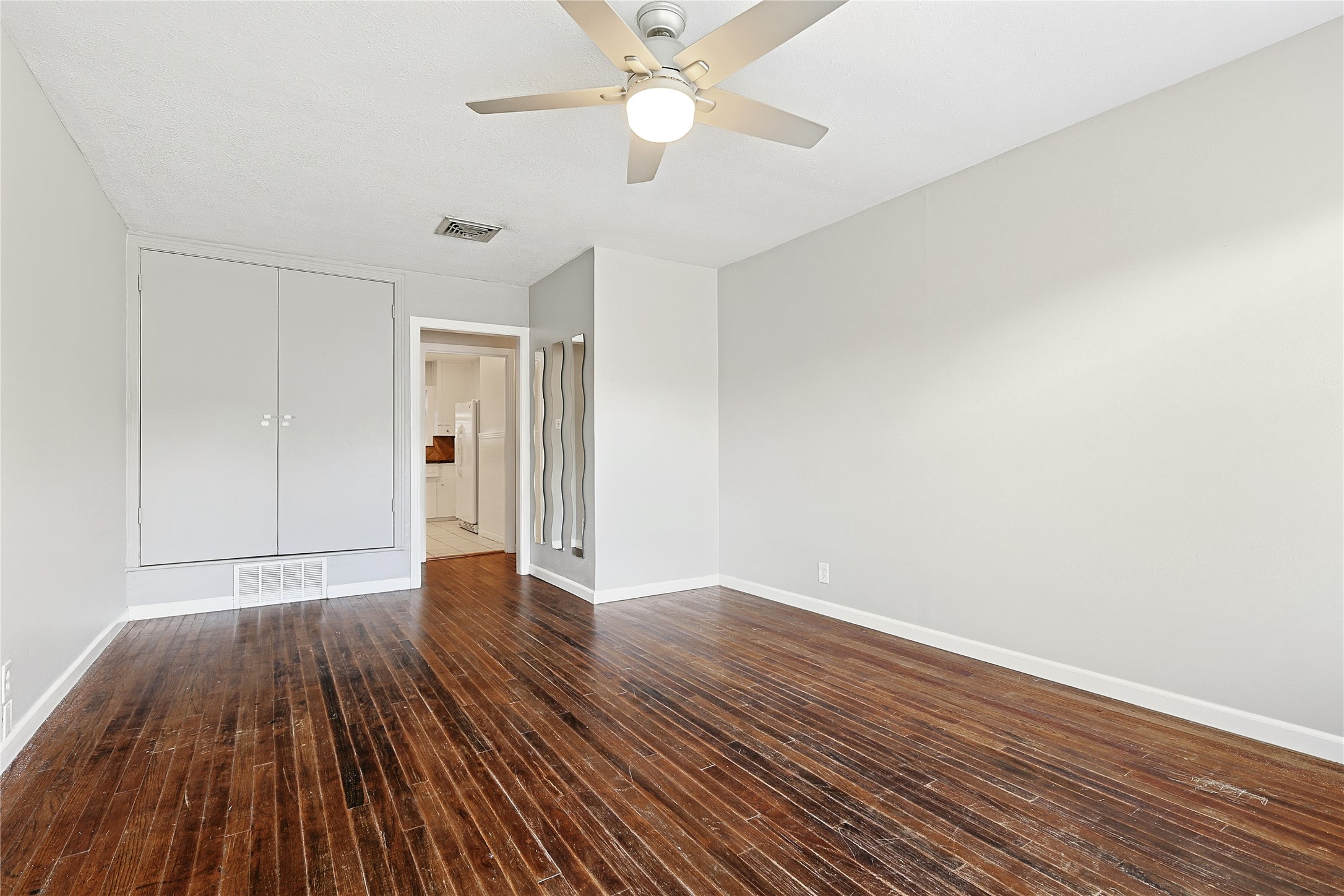 106 Trout Avenue Galveston, TX 77550 - Photo 6 of 21 wooden floor in an empty room with a window