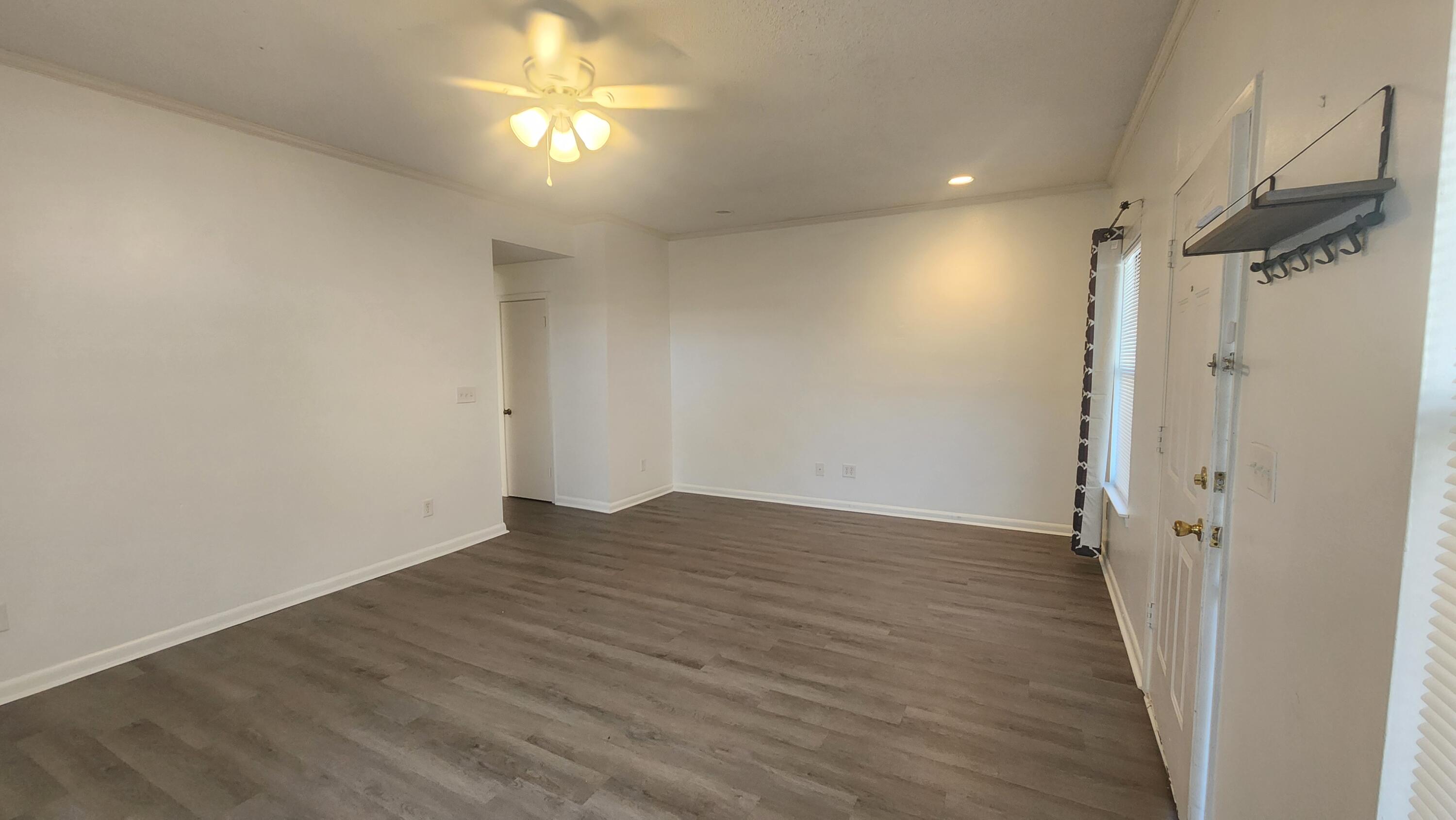 205 Marquette Avenue, Unit 1 Niceville, FL 32578 - Photo 12 of 16 a view of empty room with wooden floor and fan