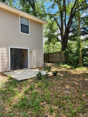 a backyard of a house with table and chairs