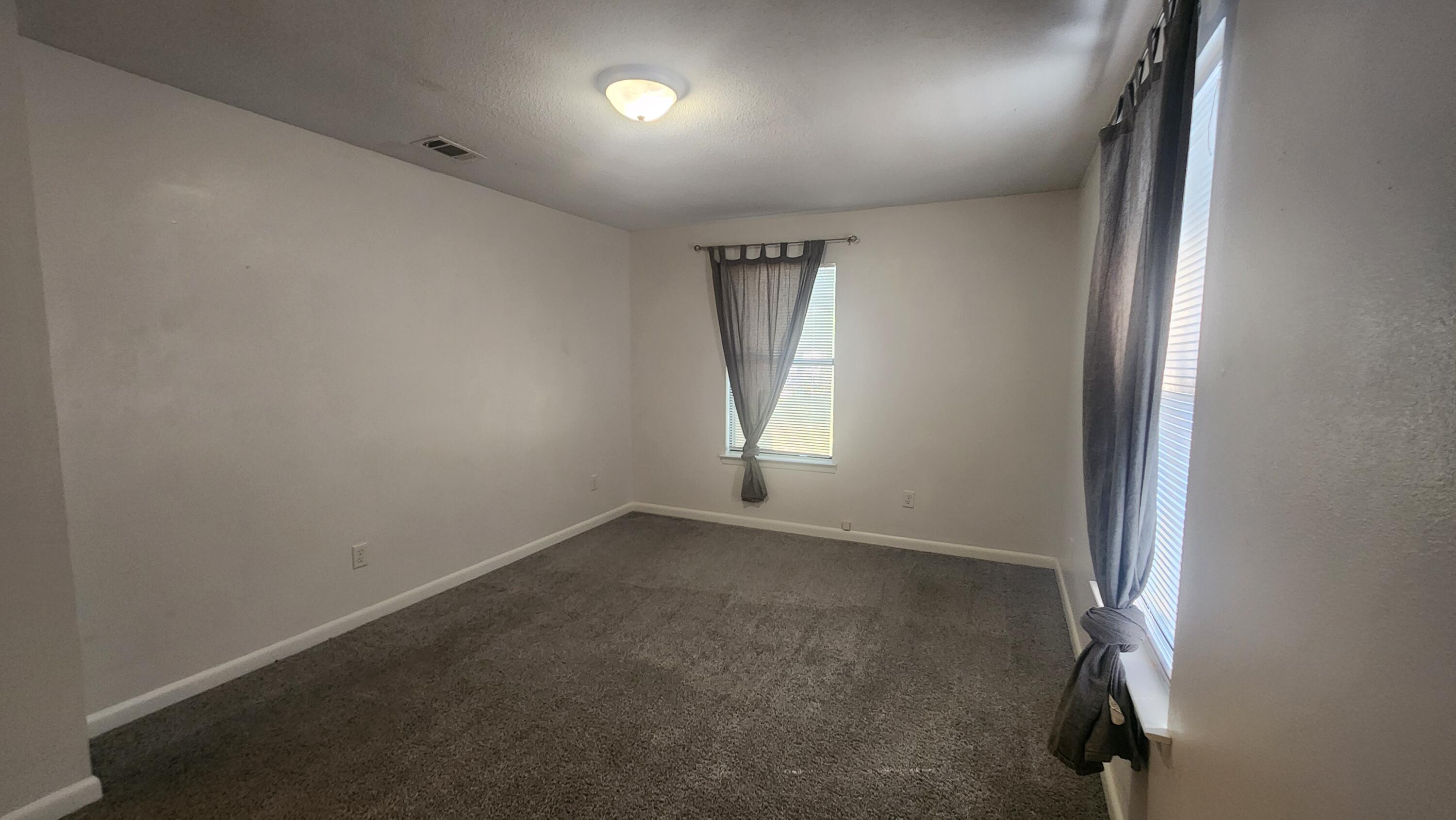 205 Marquette Avenue, Unit 1 Niceville, FL 32578 - Photo 3 of 16 an empty room with windows