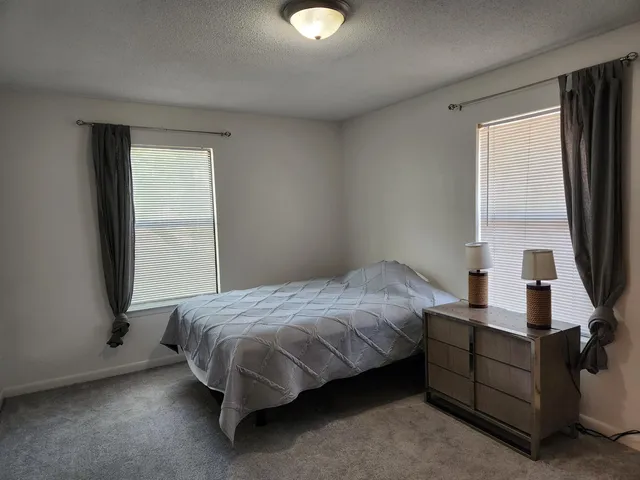 a bedroom with a bed and window